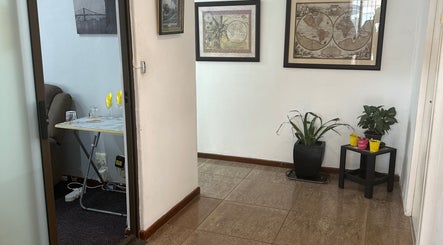 Serene entrance with plants and art at Serenity Wellness & Beauty Spa, Gqeberha, Eastern Cape, ZA.