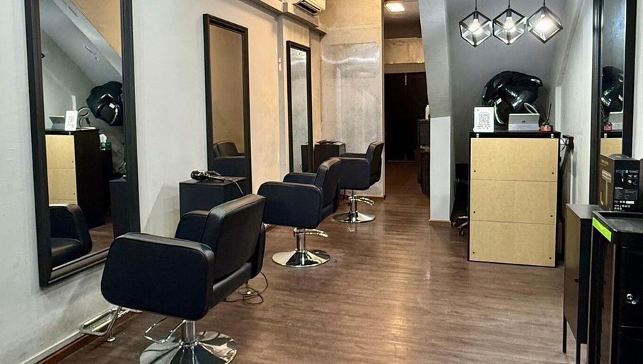 Interior of Scissors Society in Singapore, Singapore, SG with modern salon chairs and sleek mirrors.