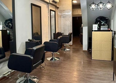 Interior of Scissors Society in Singapore, Singapore, SG with modern salon chairs and sleek mirrors.