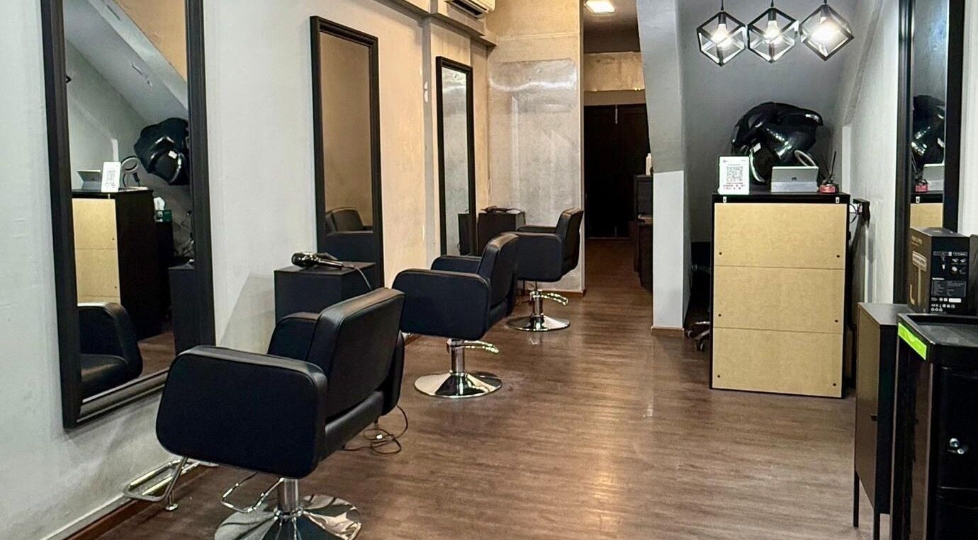 Interior of Scissors Society in Singapore, Singapore, SG with modern salon chairs and sleek mirrors.