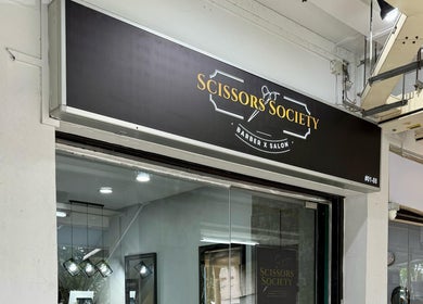 Exterior view of Scissors Society in Singapore, SG, showcasing modern barber salon design.