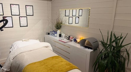 Tranquil treatment room at Skin.Cetra, Guildford, England, GB with cozy bed and calming decor.