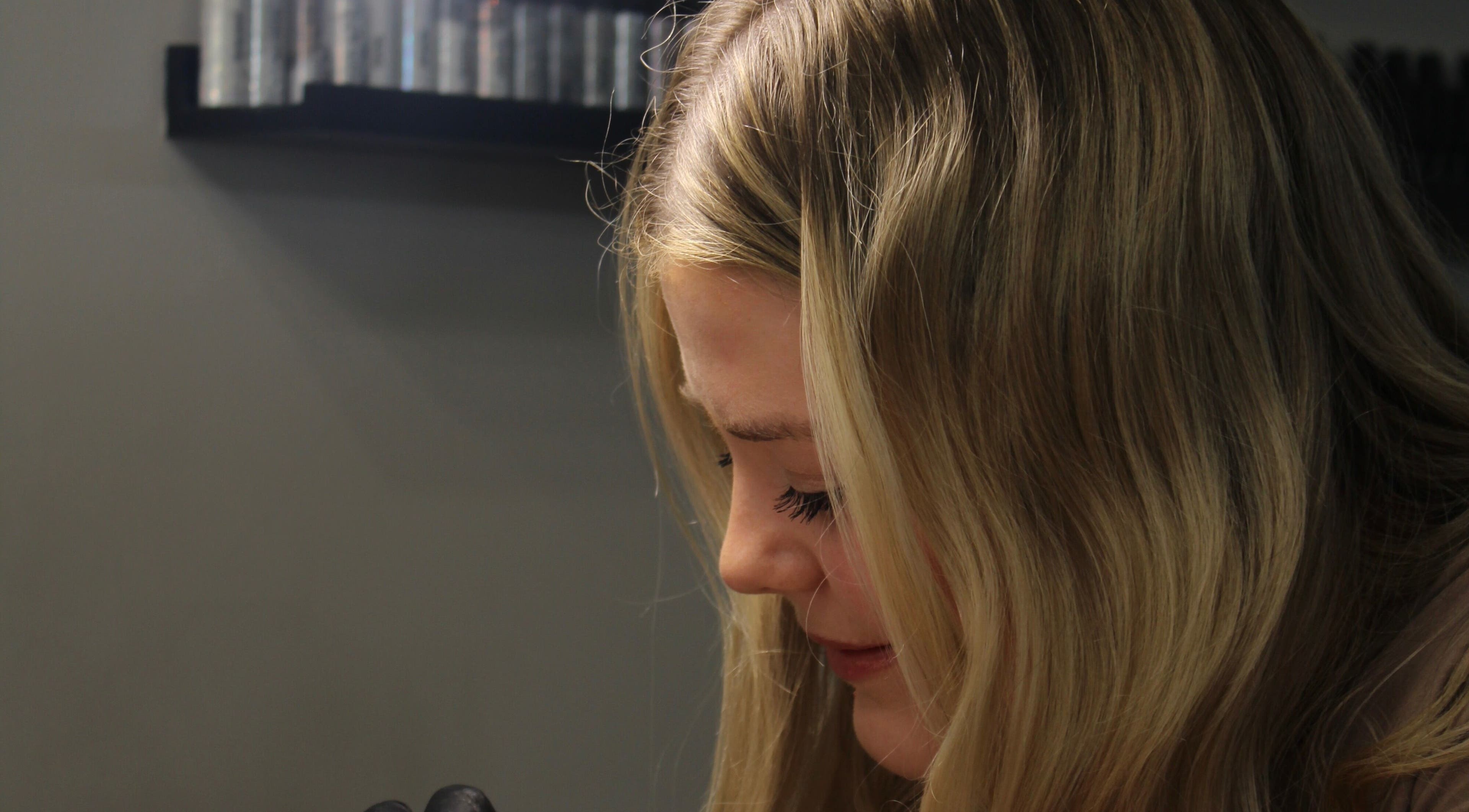 Detail of a skilled nail technician at Nailzbycode, Kidderminster, England, GB, focusing on her work.
