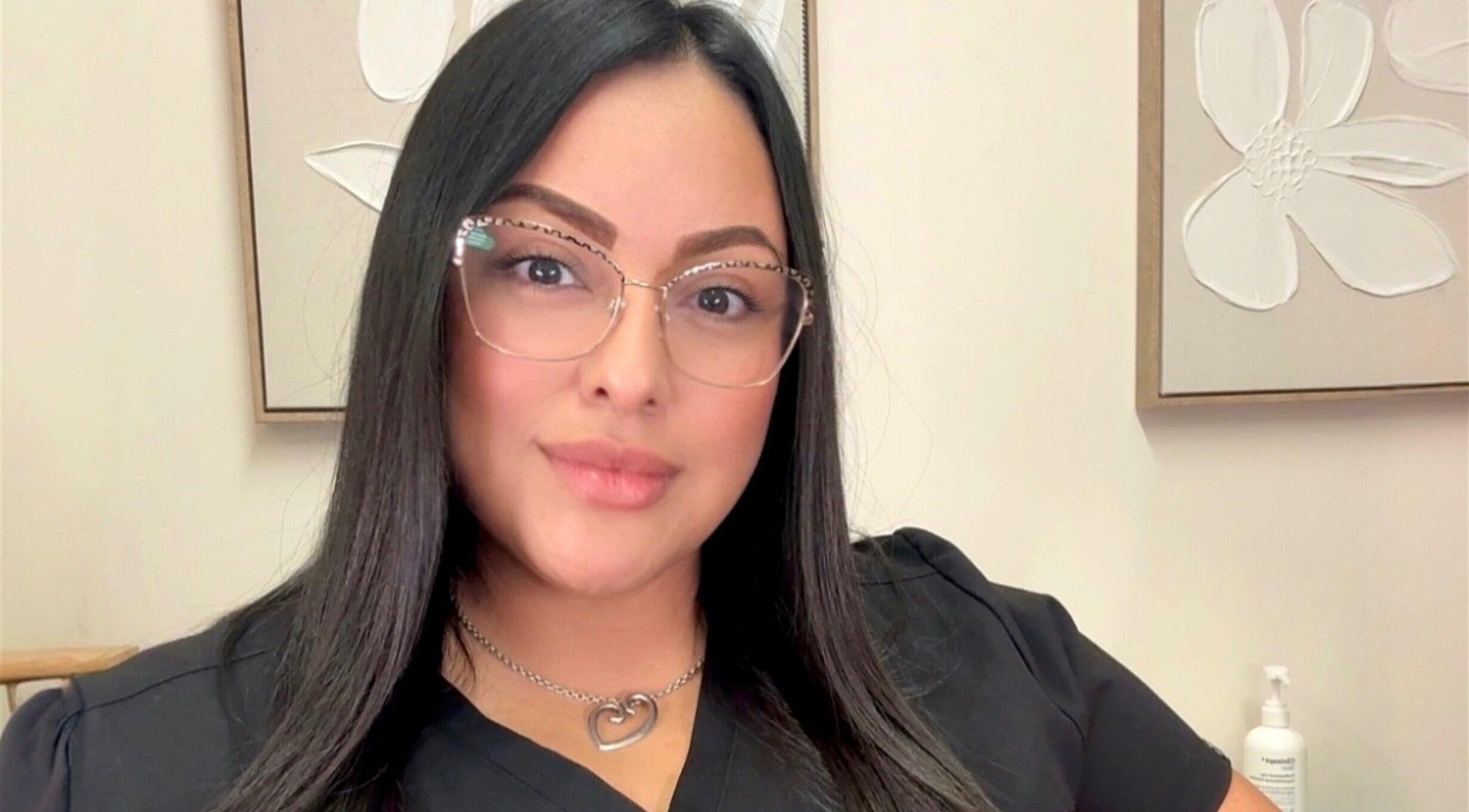 Smiling employee at Injexed Aesthetics & Wellness, Lytle, Texas, US, enhancing client experience.