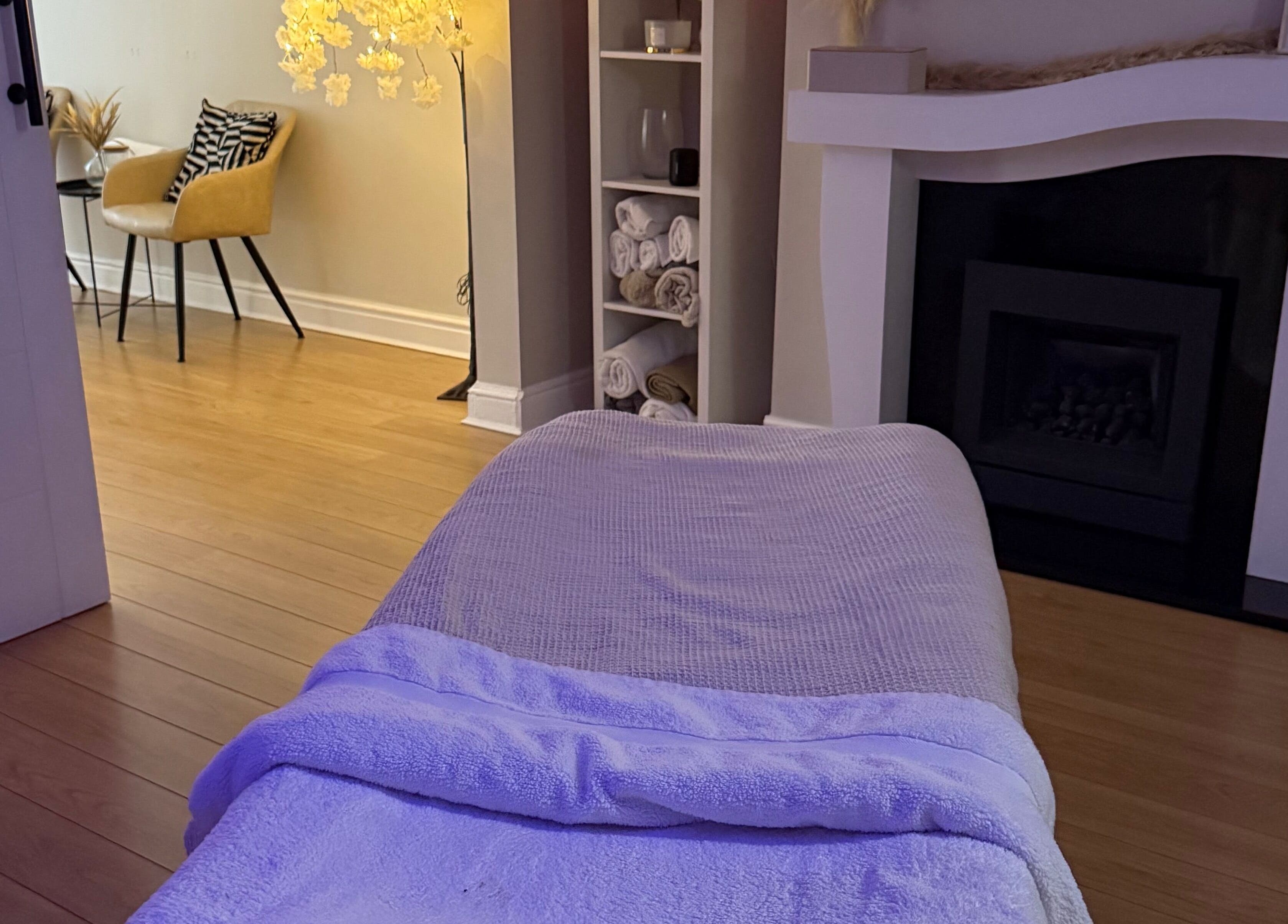 Calming massage room at Touch Of Shannon, Workington, England, GB, with soft lighting and cozy decor.