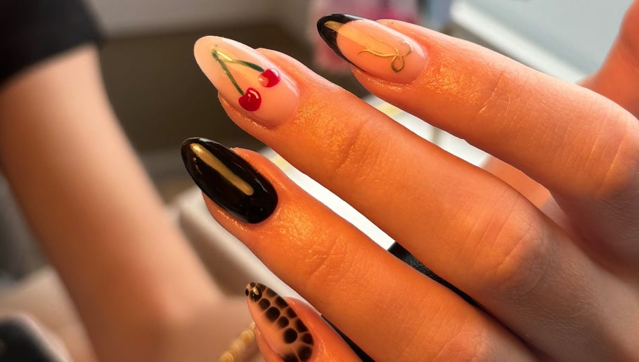 Stylish nail art featuring cherry and abstract designs at Biabs By Abs, Llansamlet, Wales, GB.