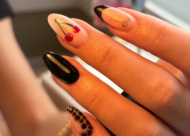 Stylish nail art featuring cherry and abstract designs at Biabs By Abs, Llansamlet, Wales, GB.