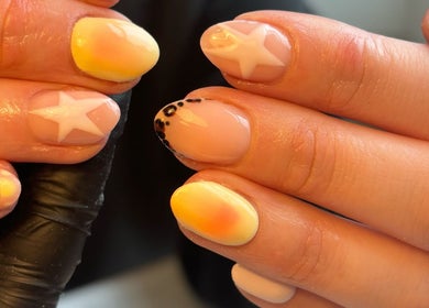 Vibrant star and sunrise nail art at Biabs By Abs, Llansamlet, Wales, GB. Ideal for a bold nail statement.