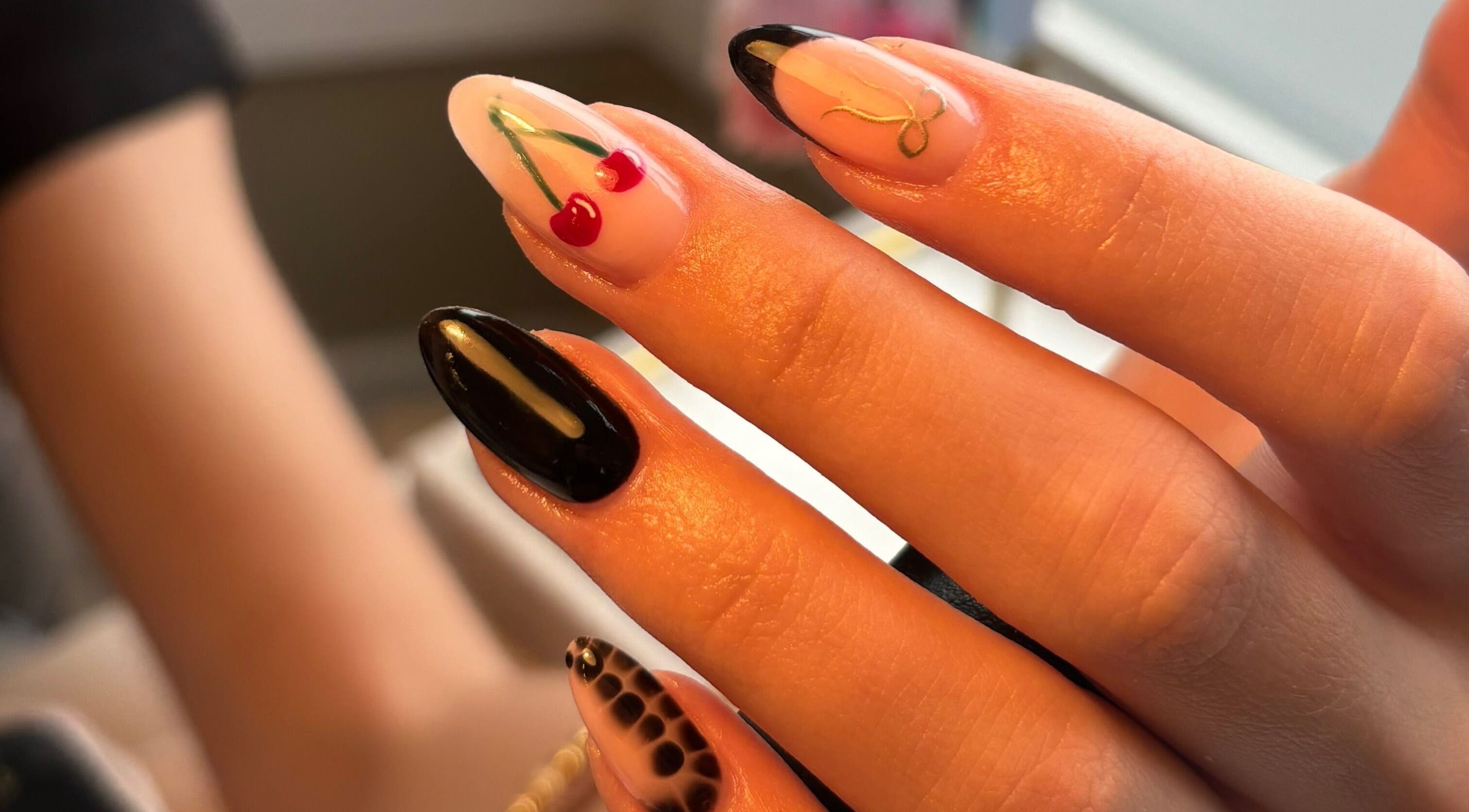 Stylish manicure with cherry, black, and marble designs at Biabs By Abs, Llansamlet, Wales, GB.