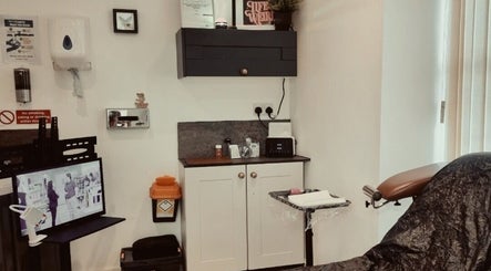 Cozy interior of Sacred Sister Tattoo in Haverfordwest, Wales, GB, showcasing a well-equipped tattoo workstation.