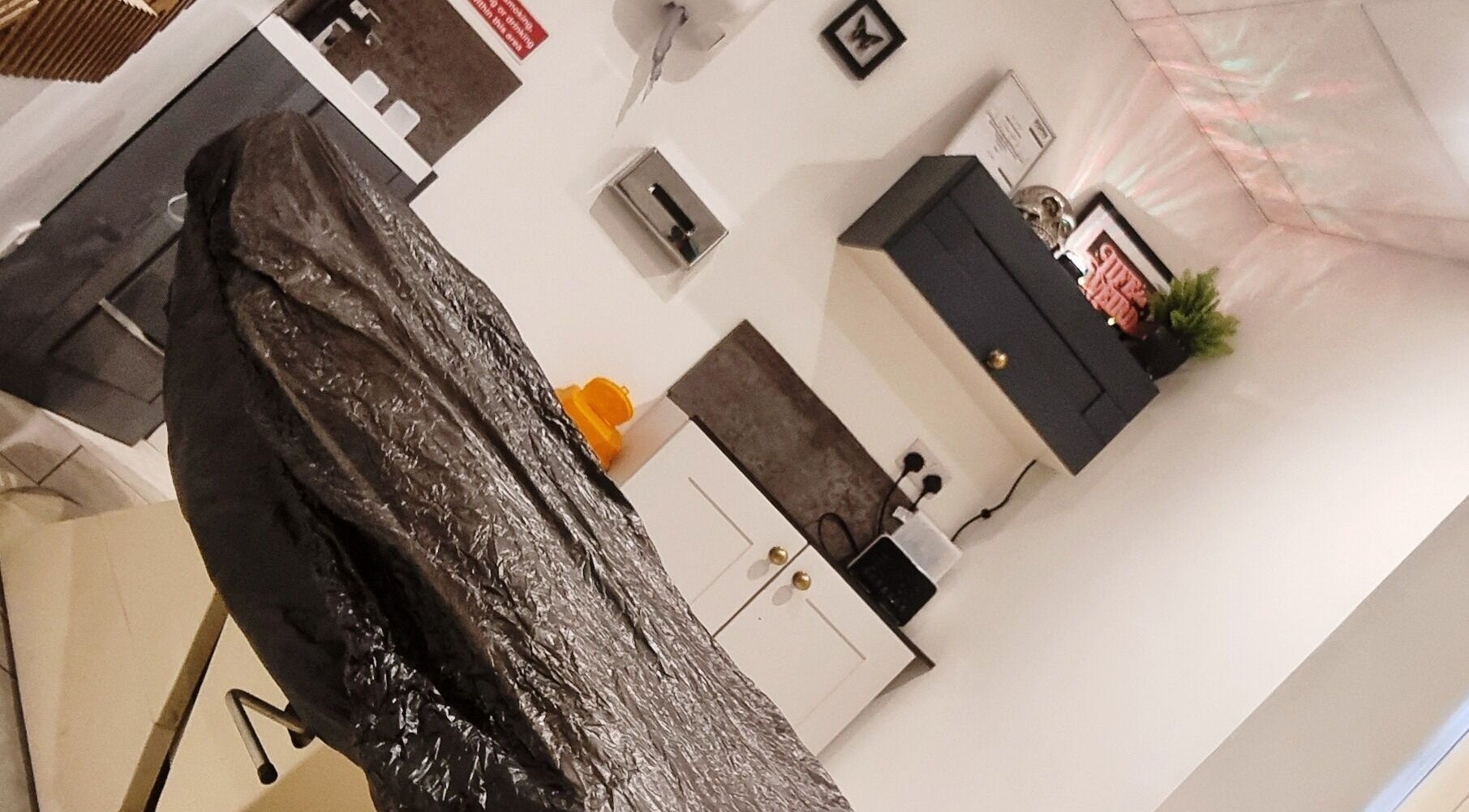 Cozy interior at Sacred Sister Tattoo, Haverfordwest, Wales, GB with a tattoo chair and decor.