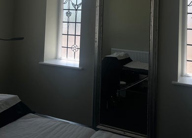 Cozy treatment room with mirror and stained glass at LashedbyLex, Sutton, England, GB.
