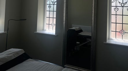 Cozy treatment room with mirror and stained glass at LashedbyLex, Sutton, England, GB.