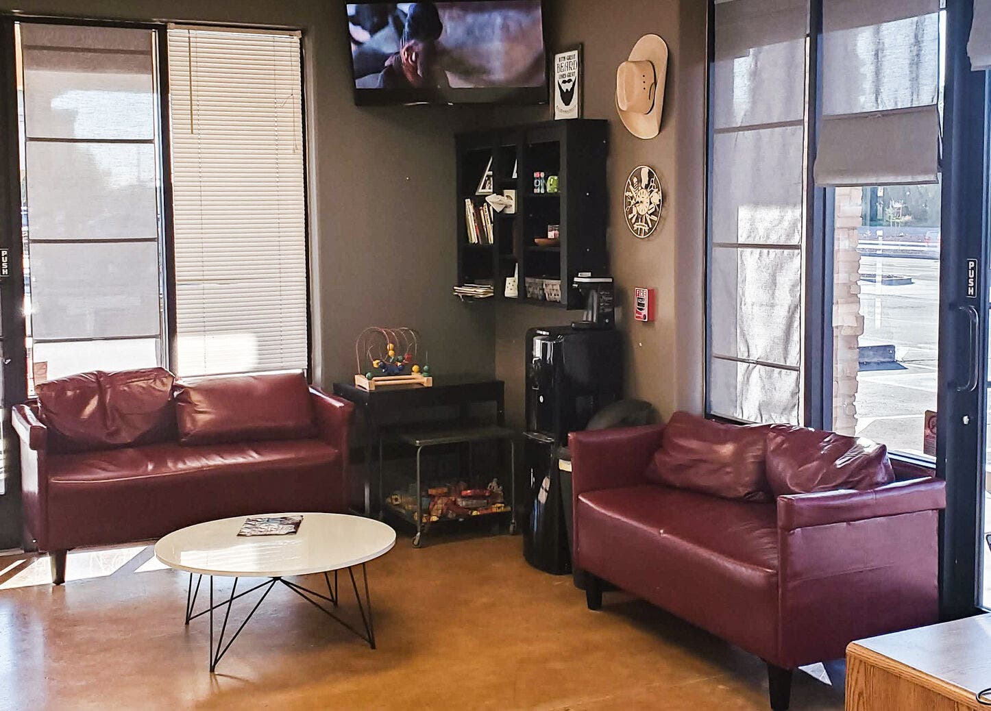 Relaxing lounge area at Joe's: A Barber Shop in Maricopa, Arizona, US with plush seating and natural light.