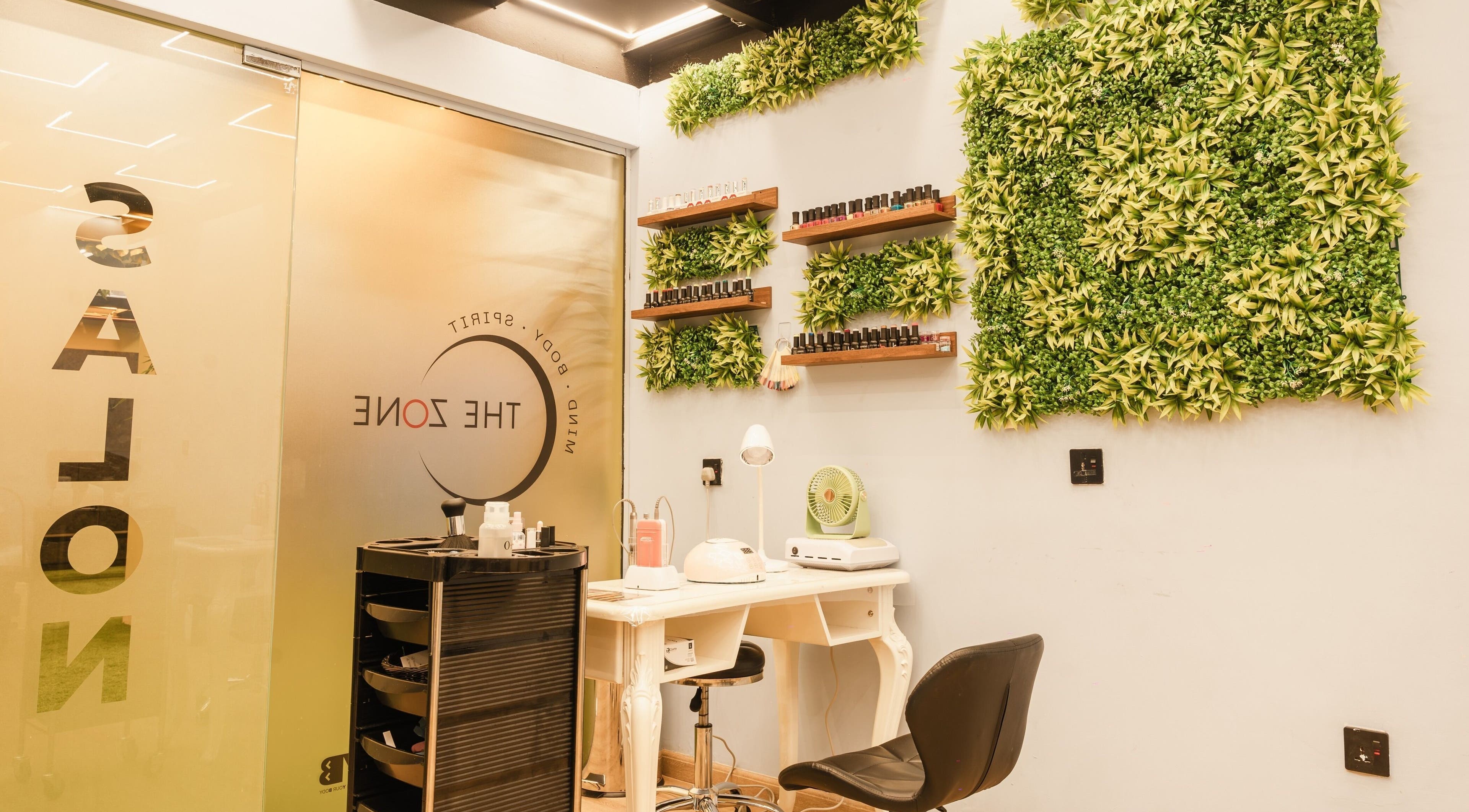 A chic nail salon at The Zone Wellness Hub, Dubai, Dubai, AE with greenery and manicure setup.