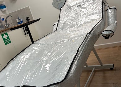 A treatment bed at Doll’s House Aesthetics in Cwmbran, Wales, GB, equipped for wellness services.