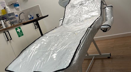 A treatment bed at Doll’s House Aesthetics in Cwmbran, Wales, GB, equipped for wellness services.