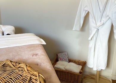 Cozy massage room at Pure Flow Massage in Bankstown, New South Wales, AU with robe and basket.