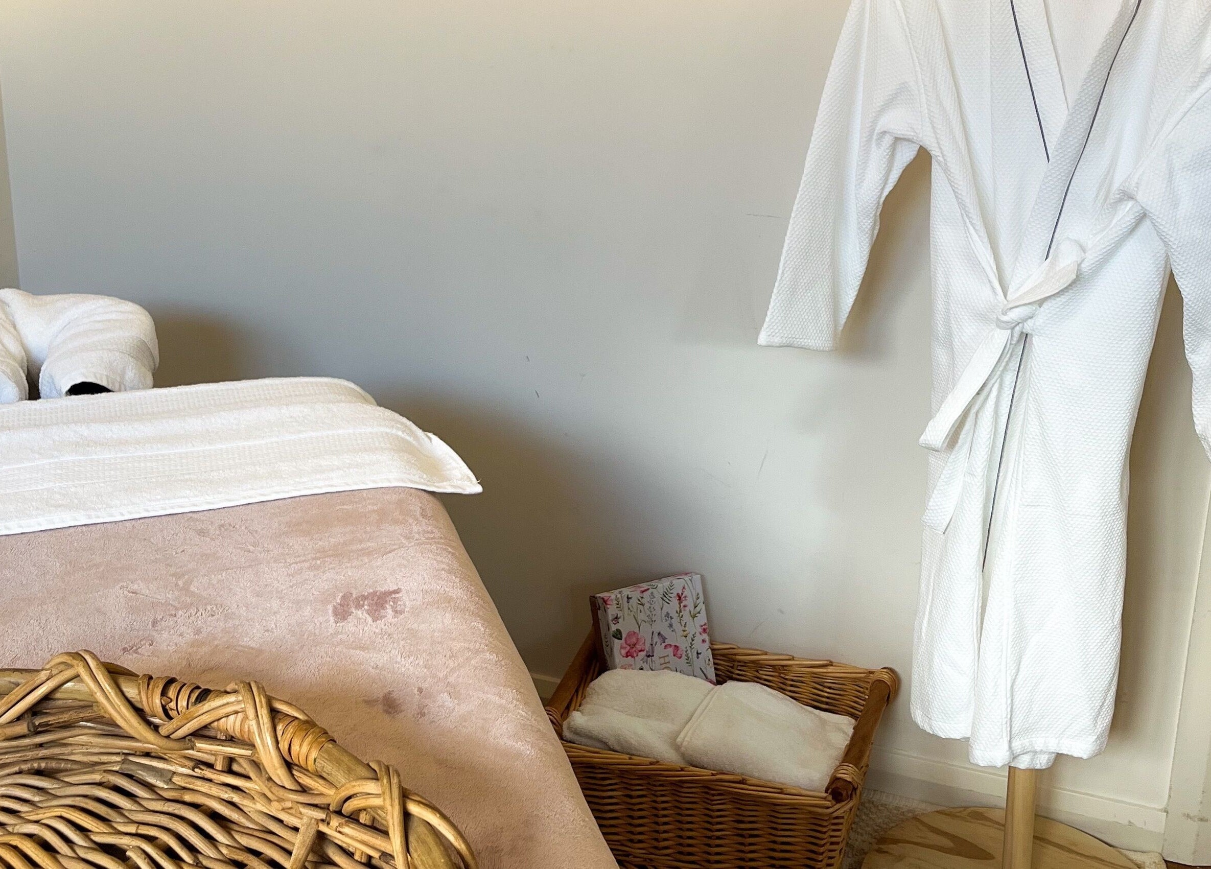 Tranquil massage room at Pure Flow Massage, Bankstown, New South Wales, AU, featuring plush towels and robe.