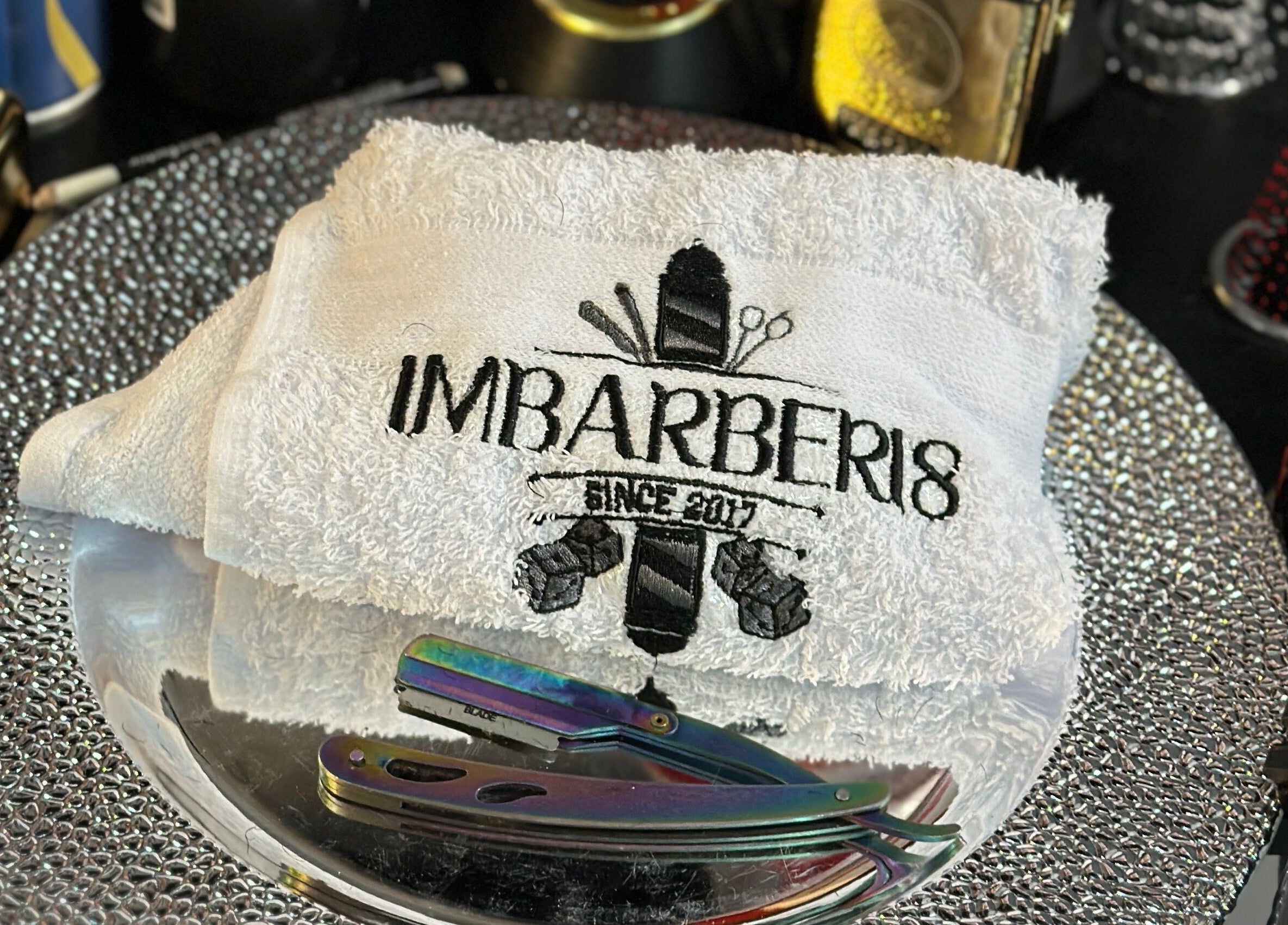 Toalla personalizada ImBarber18 - Nariño Sur en Bogotá, Bogotá, CO sobre bandeja de plata.