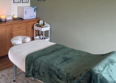 Tranquil massage room at Massage Therapy with Molly, Hassocks, England, GB with green blanket on the table.