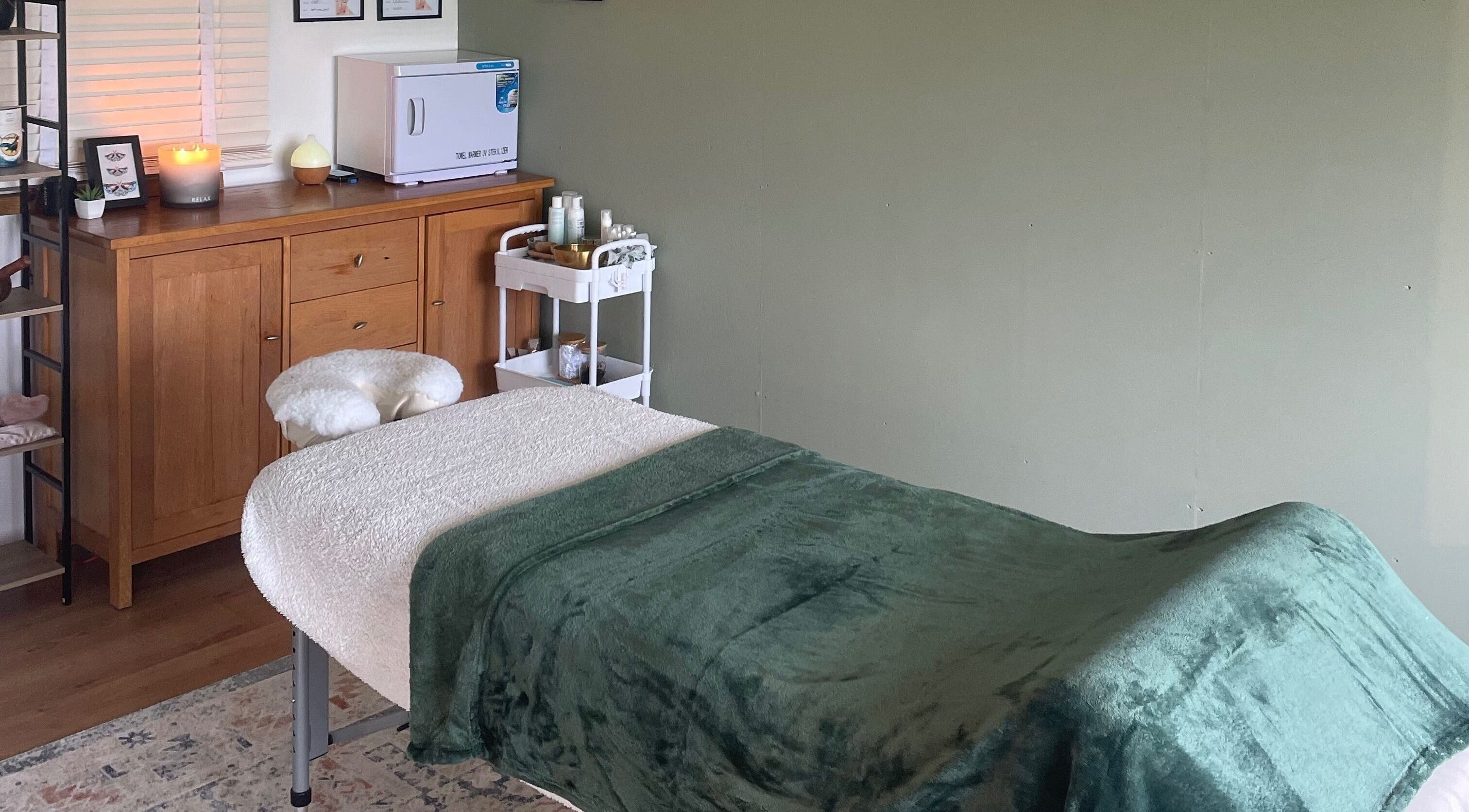 Tranquil massage room at Massage Therapy with Molly, Hassocks, England, GB with green blanket on the table.