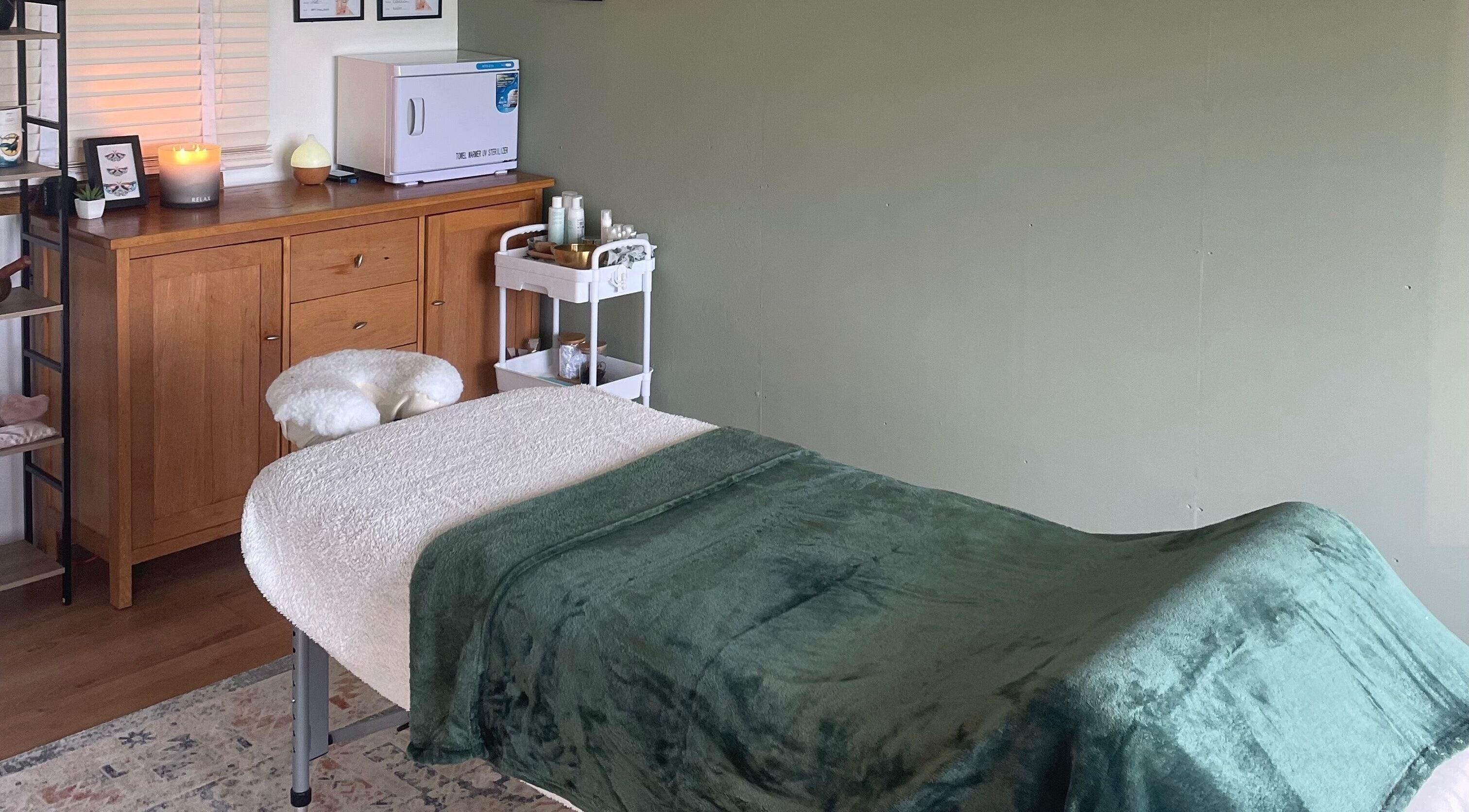 Tranquil massage room at Massage Therapy with Molly, Hassocks, England, GB with green blanket on the table.