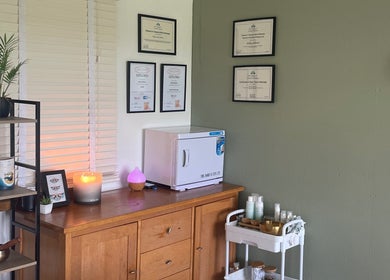 Cozy therapy room at Massage Therapy with Molly, Hassocks, England, GB featuring certificates and wellness products.