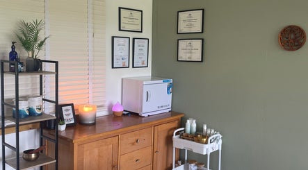 Cozy therapy room at Massage Therapy with Molly, Hassocks, England, GB featuring certificates and wellness products.