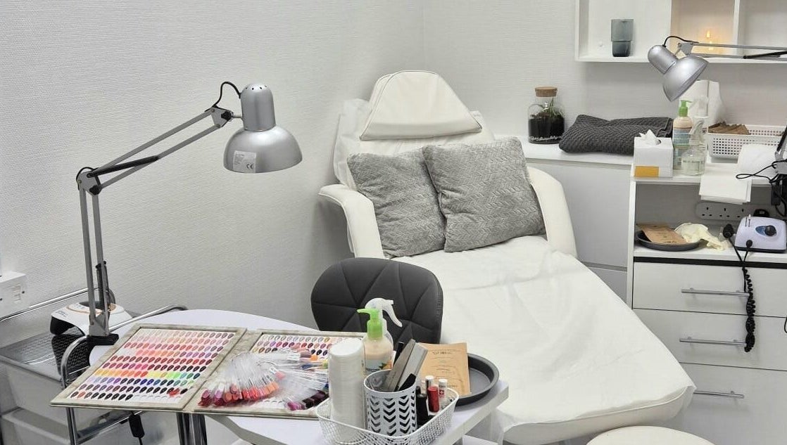 Nail salon setup at Kingston Health Studio, Kingston Upon Thames, England, GB. Cozy chair and nail polish display.