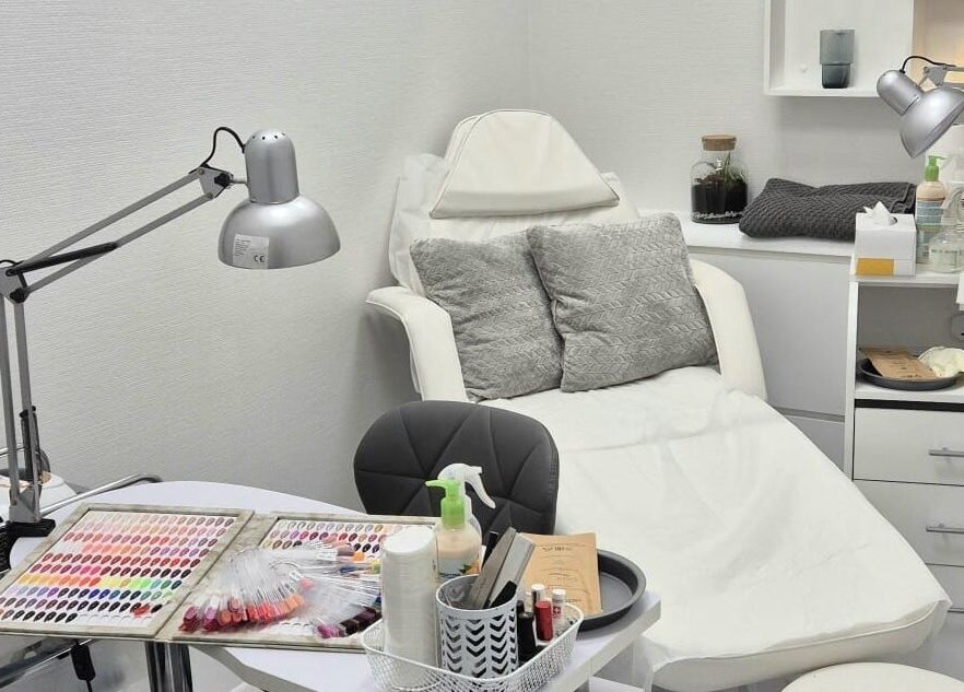 Nail salon setup at Kingston Health Studio, Kingston Upon Thames, England, GB. Cozy chair and nail polish display.