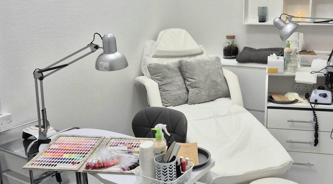 Nail salon setup at Kingston Health Studio, Kingston Upon Thames, England, GB. Cozy chair and nail polish display.