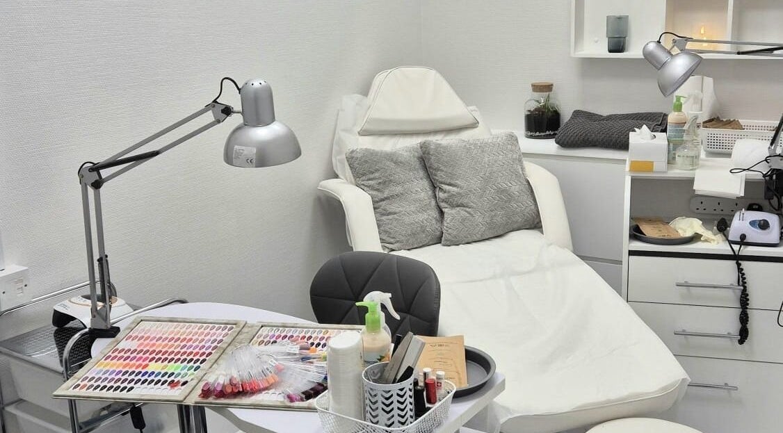 Nail salon setup at Kingston Health Studio, Kingston Upon Thames, England, GB. Cozy chair and nail polish display.