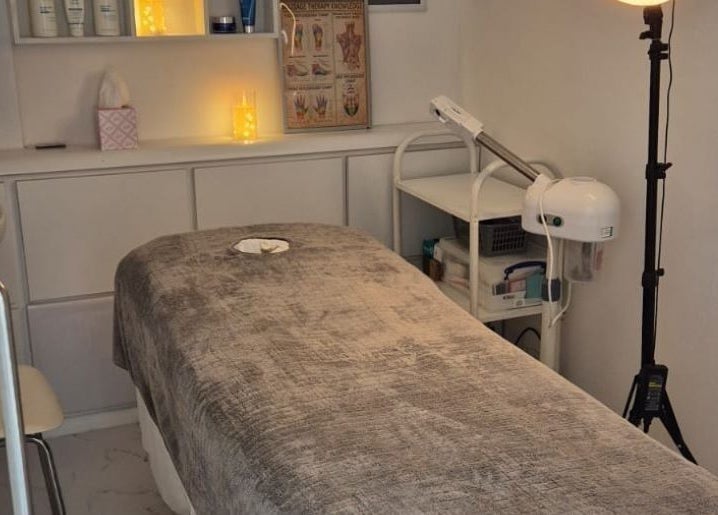 Relaxing treatment room at Kingston Health Studio, Kingston Upon Thames, England, GB, with ambient lighting and a massage bed.