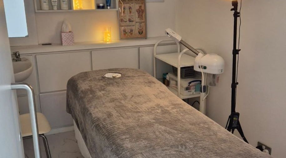 Relaxing treatment room at Kingston Health Studio, Kingston Upon Thames, England, GB, with ambient lighting and a massage bed.