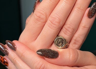 Stylish brown glitter nails at Ellsbeautymark in Aveley, England, GB showcasing elegant nail art.