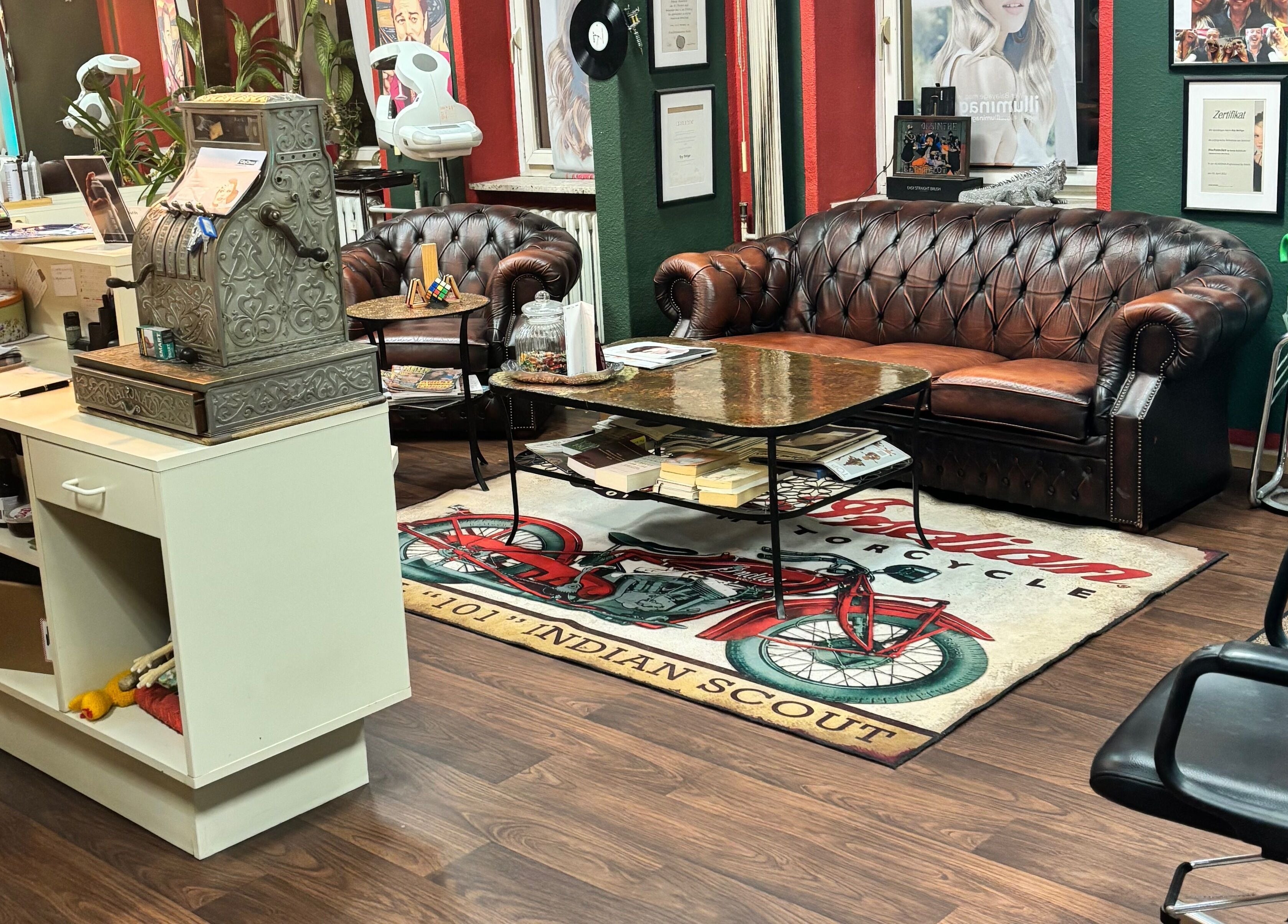 Stilvolle Wartebereich bei Roy's Friseurteam in Berlin, Berlin, DE mit Ledersofa und Vintage-Dekor.