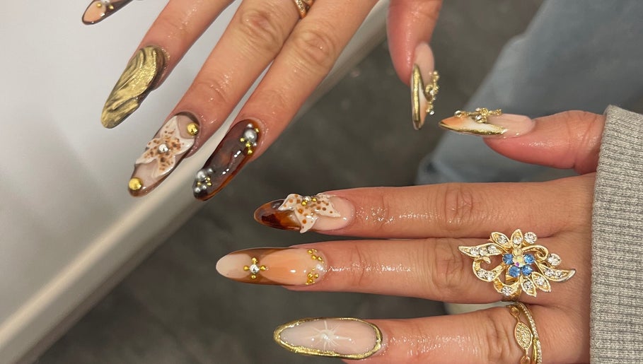 Intricate nail art with gemstones at V Lbeauty Mcr, Manchester, England, GB, showcasing luxury and style.