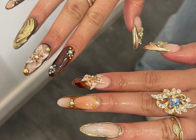 Intricate nail art with gemstones at V Lbeauty Mcr, Manchester, England, GB, showcasing luxury and style.