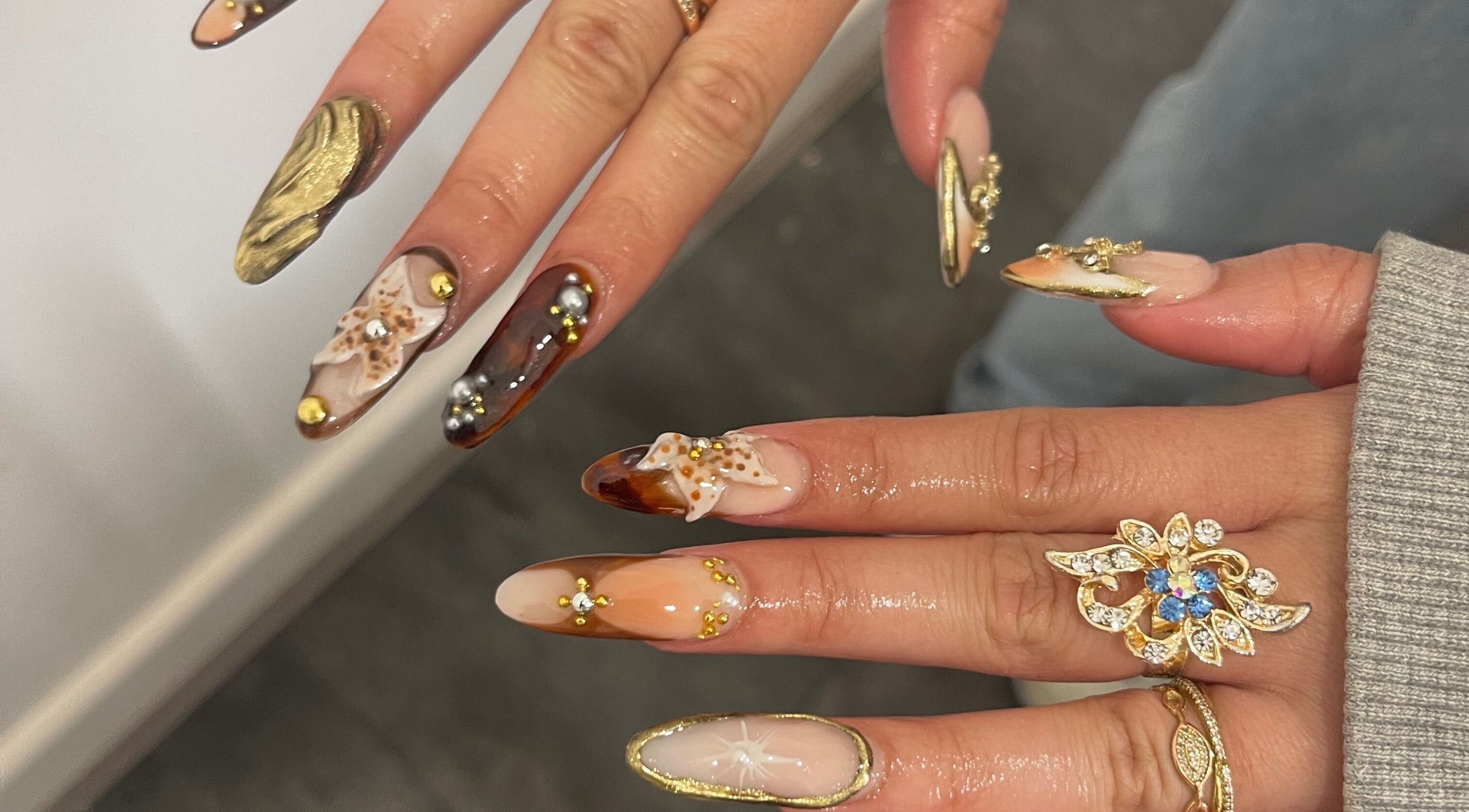 Intricate nail art with gemstones at V Lbeauty Mcr, Manchester, England, GB, showcasing luxury and style.