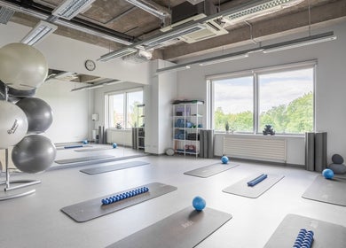 Spacious fitness room at FIZIO LINE, Rīga, LV with mats and exercise balls.