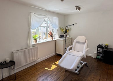Serene treatment room at Rare Aesthetics UK, Brighton And Hove, GB with comfortable chair and natural light.