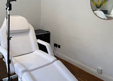 Aesthetic treatment chair in Rare Aesthetics UK, Brighton And Hove, GB, with elegant interior decor.