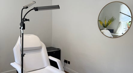 Bright treatment room at Rare Aesthetics UK, Brighton And Hove, GB with modern white chair and minimal decor.