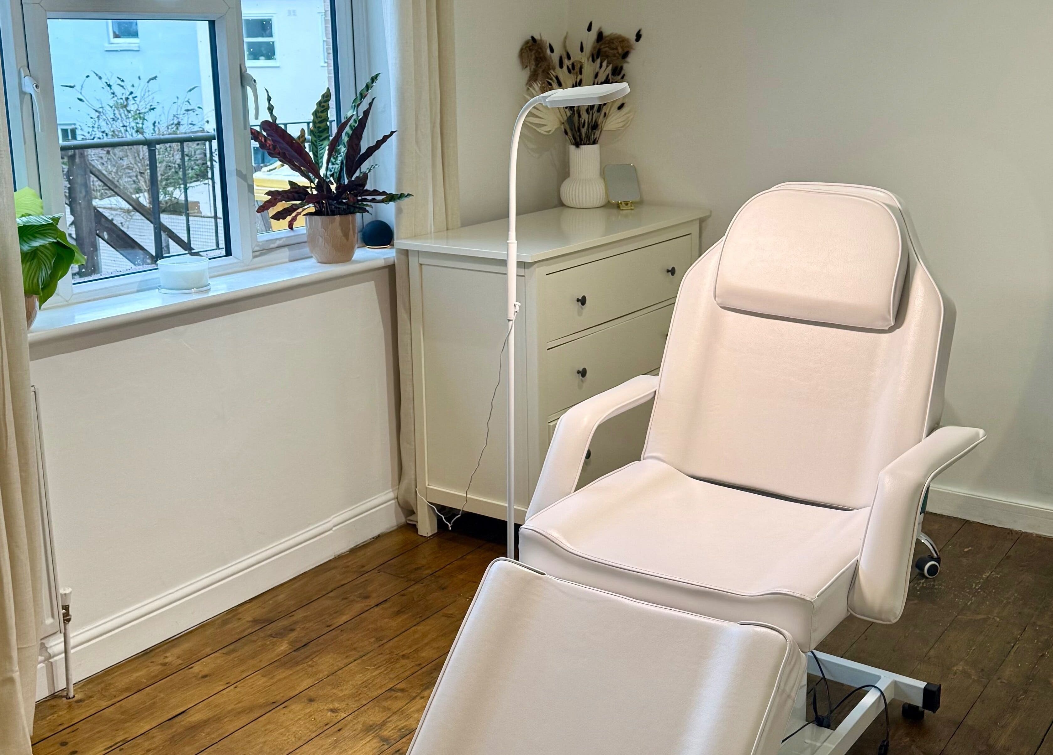 Calm and inviting treatment room at Rare Aesthetics UK, Brighton And Hove, GB, featuring a comfortable recliner.