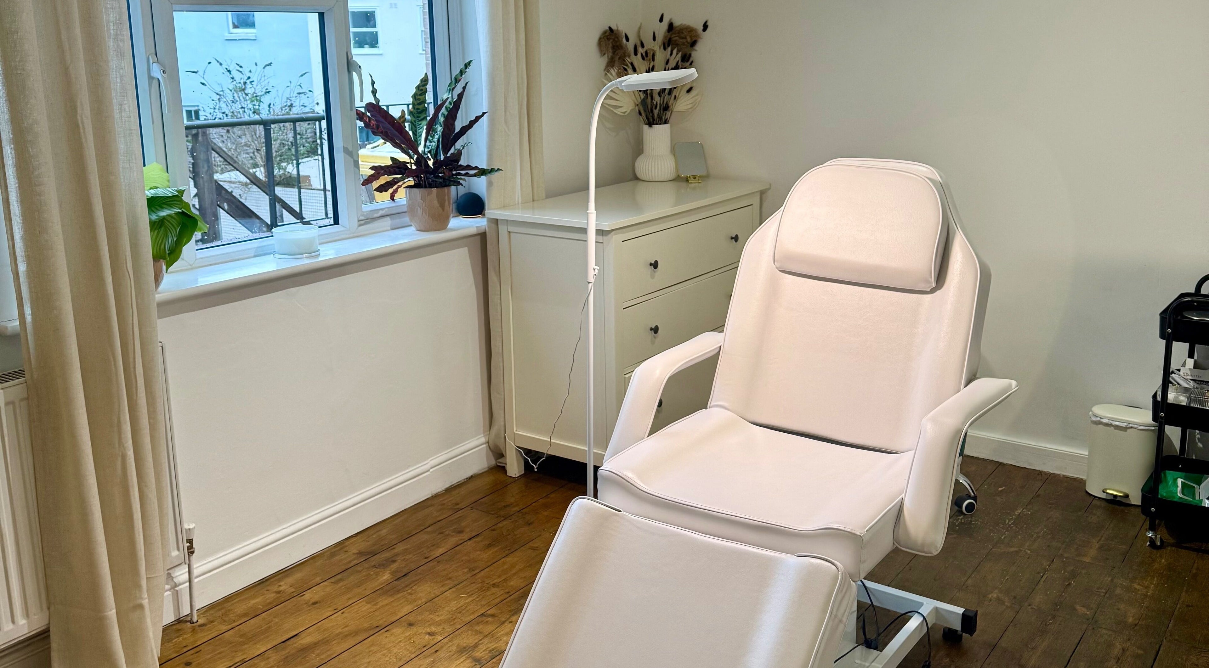 Calm and inviting treatment room at Rare Aesthetics UK, Brighton And Hove, GB, featuring a comfortable recliner.