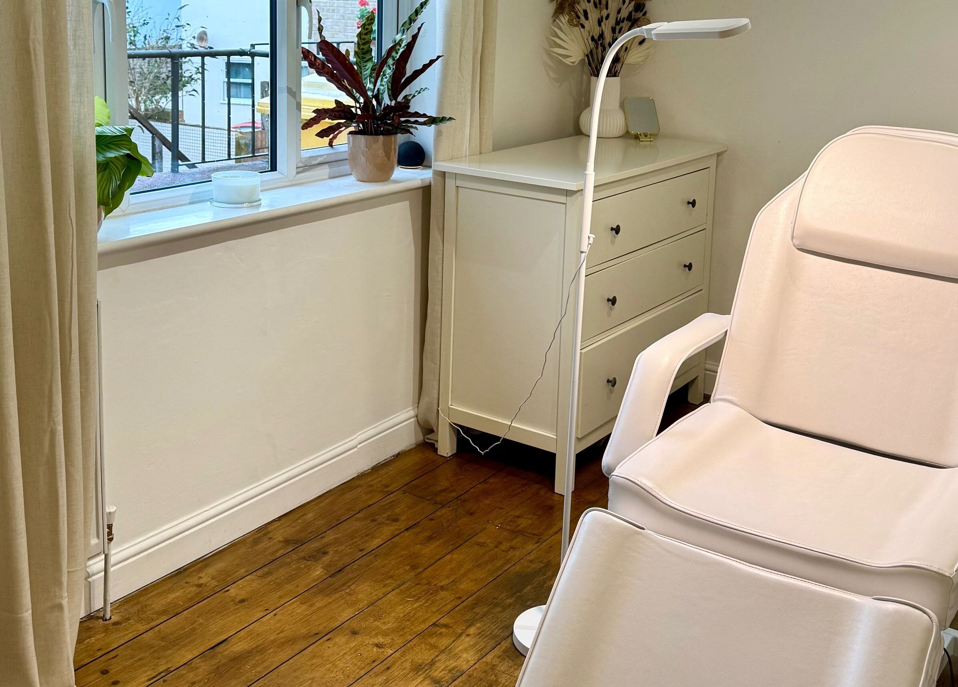 A serene treatment room at Rare Aesthetics UK, Brighton And Hove, GB featuring a plush spa chair and calming decor.