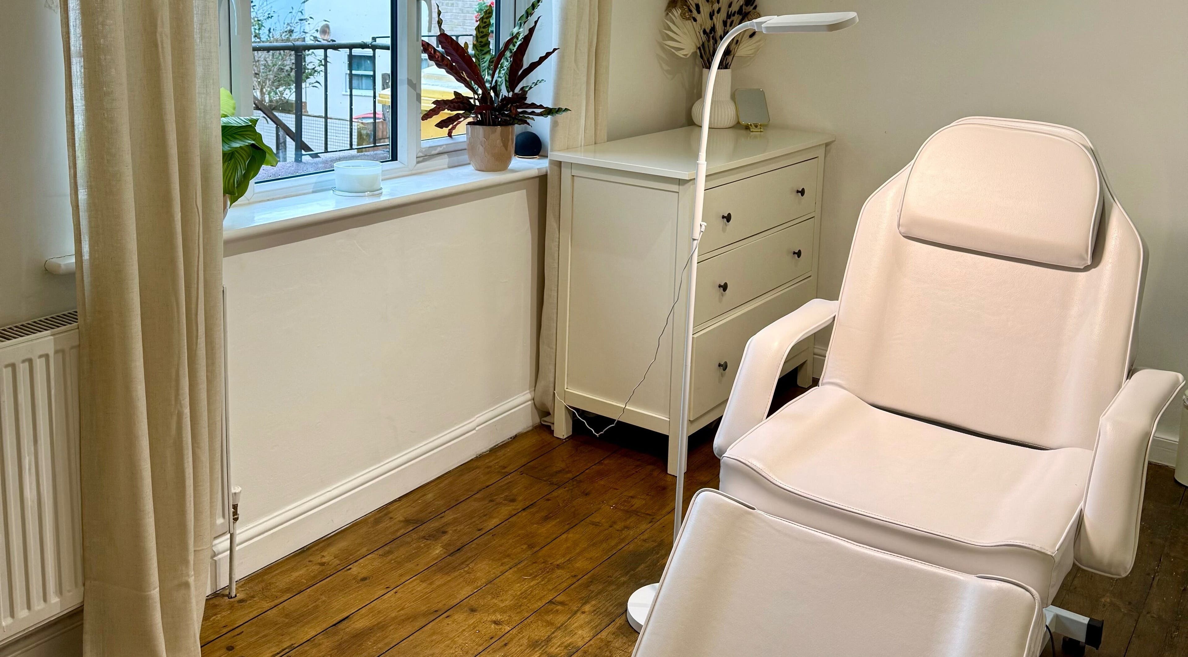 A serene treatment room at Rare Aesthetics UK, Brighton And Hove, GB featuring a plush spa chair and calming decor.