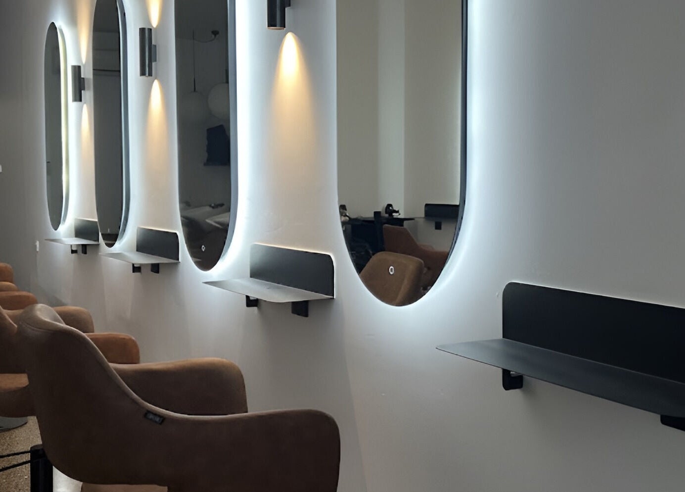 Modern salon with chic mirrors at Hair by Hustle and Co, Richmond, Victoria, AU.