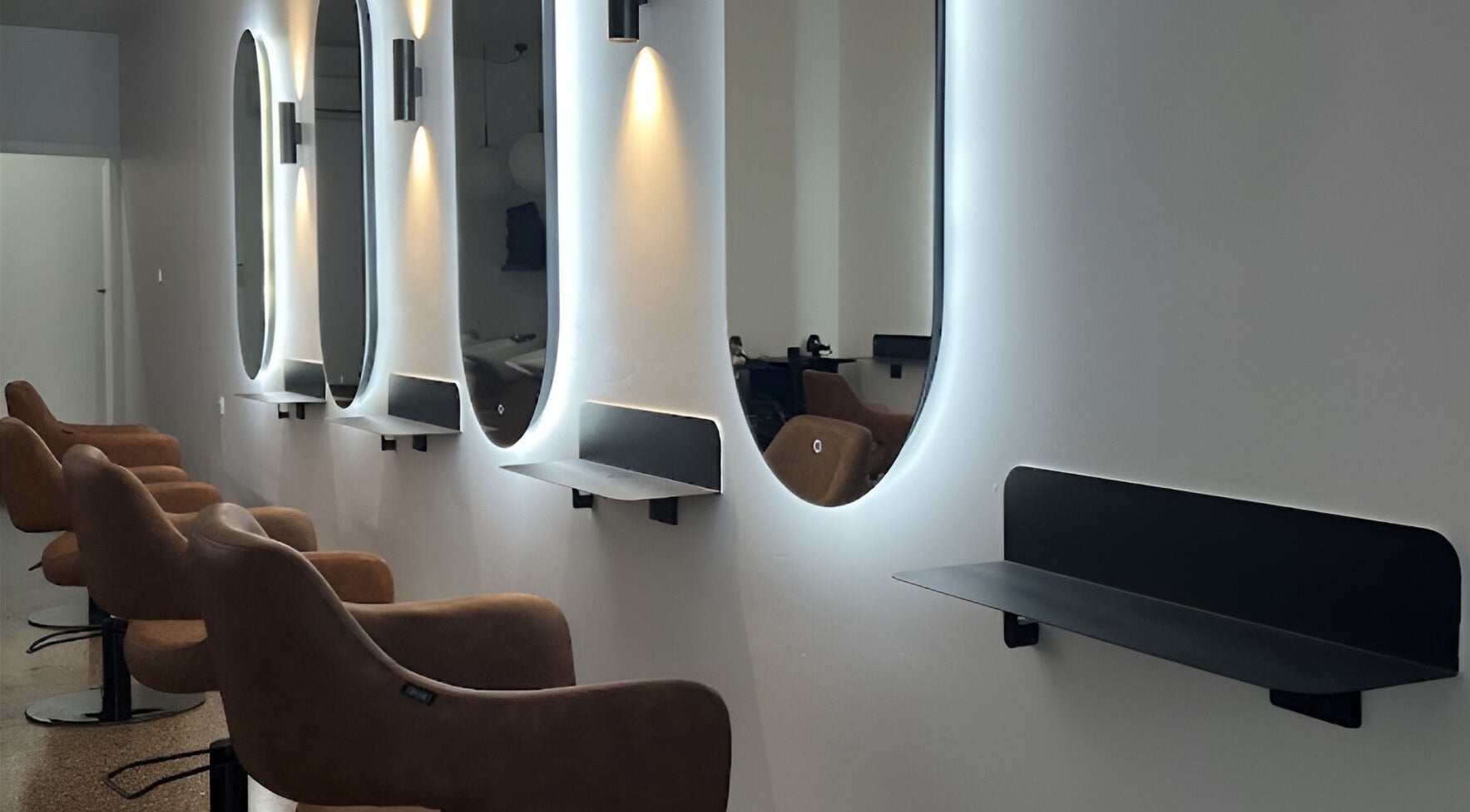 Modern salon with chic mirrors at Hair by Hustle and Co, Richmond, Victoria, AU.